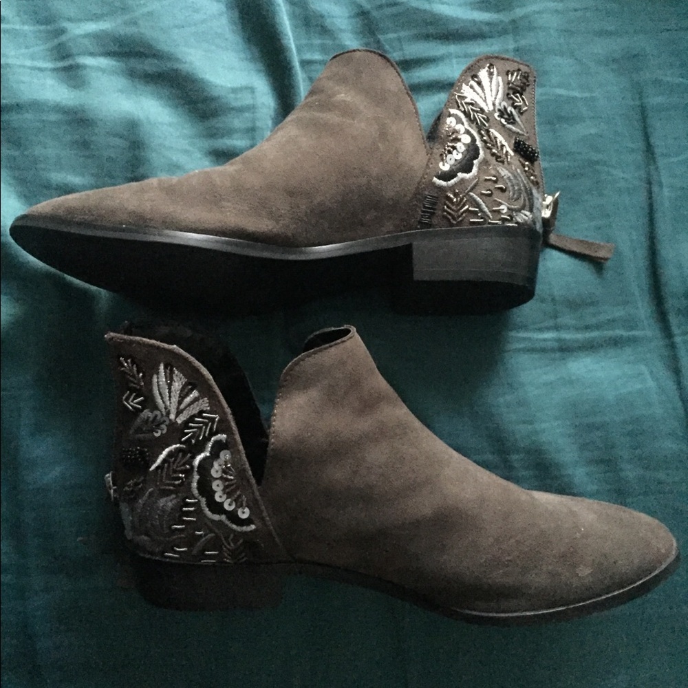 Grey suede booties with embroidery on heels